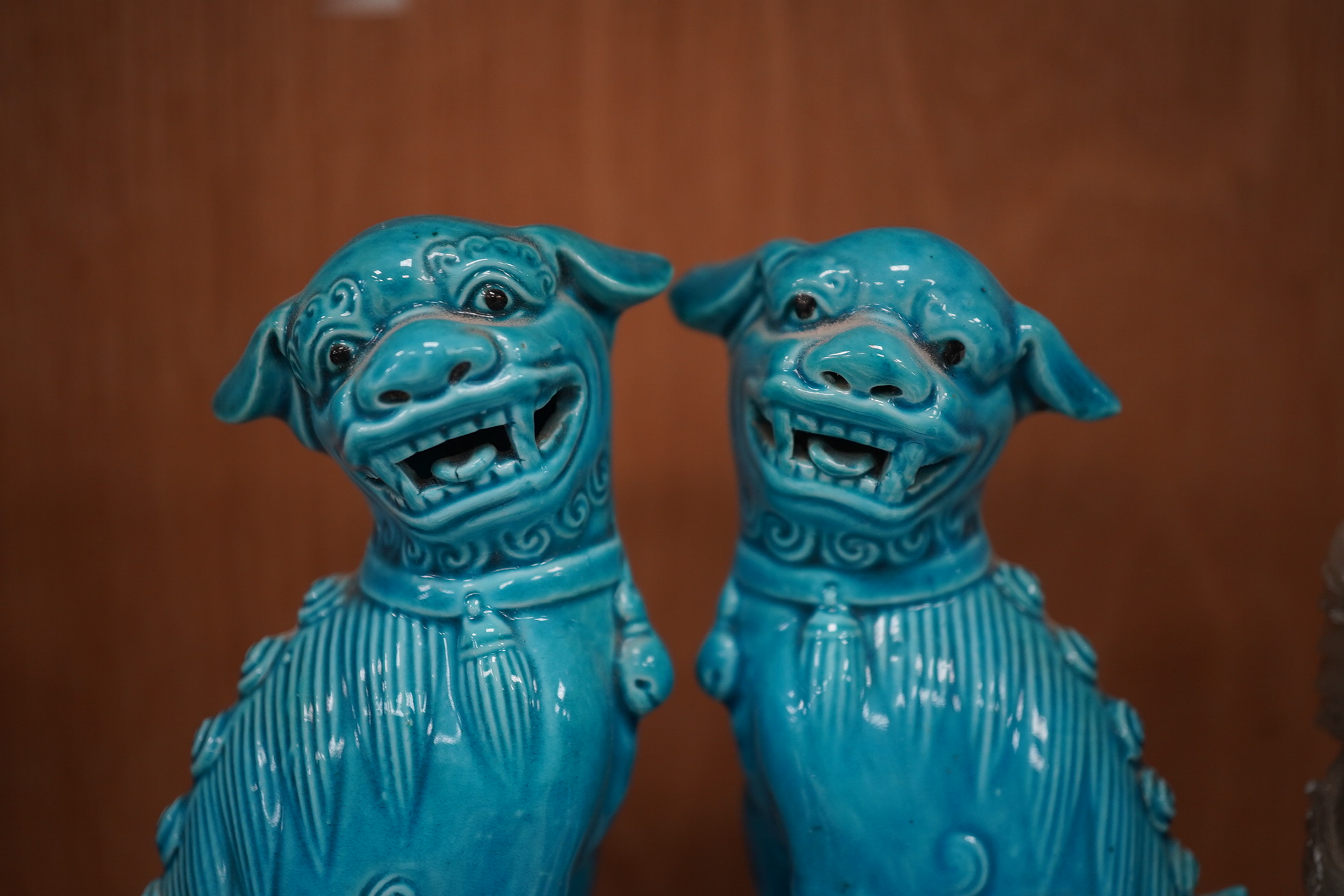 A group of Chinese items; a pair of turquoise glazed ceramic lion dogs, two pairs of soapstone carvings, various ‘dragon’ carvings etc. Condition - fair to good